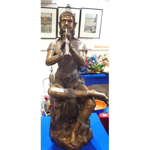 306 - A bronze of a Thai figure playing an instrument, 62cm high