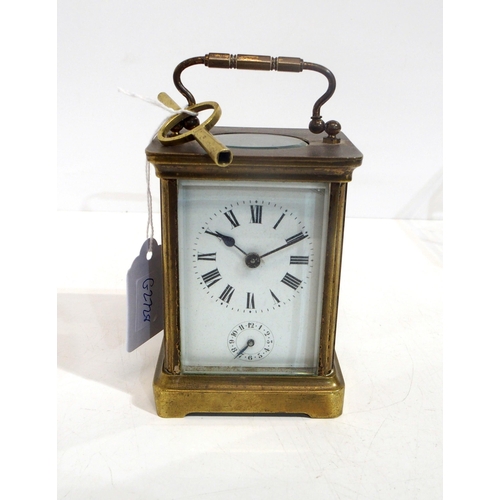 316 - A brass and glass alarm carriage clock, has key