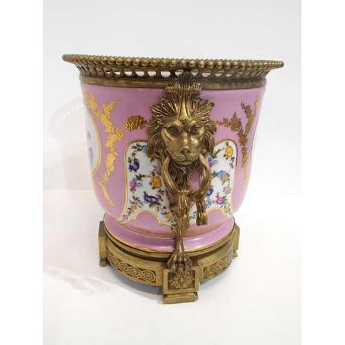 318 - A continental jardinière decorated with cherubs in a gilt metal mount with lions mask handles... 