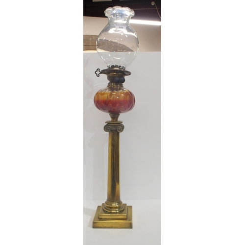 320 - A Victorian brass column oil lamp with glass font and shade, 82cm high