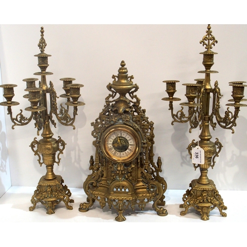 336 - A West German gilt metal clock with candelabra garniture