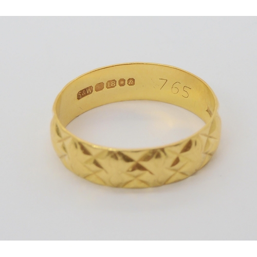 697 - An 18ct gold bright cut decorated wedding ring, size Q, weight 3.6gms