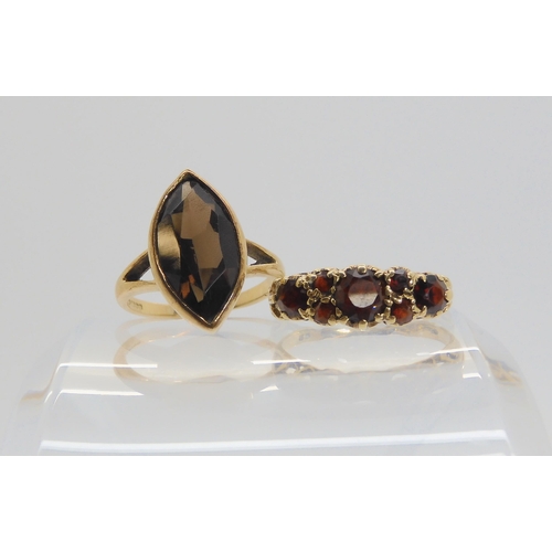699 - A 9ct gold marquis shaped smoky quartz ring, size K, together with a garnet set ring, size L1/2, wei... 