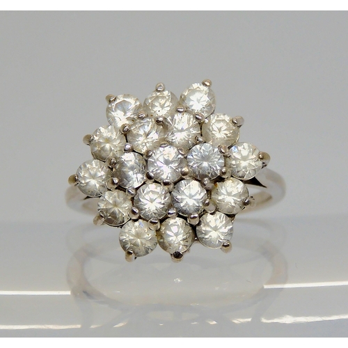 700 - An 18ct gold clear gem cluster ring, size N1/2, weight 5.6gms