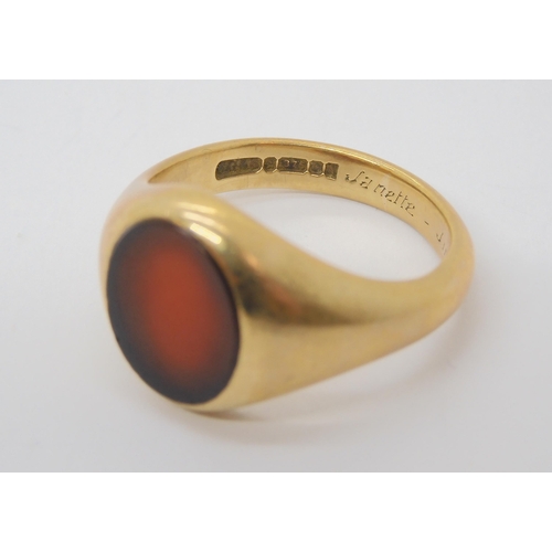 701 - A heavy weight 9ct gold gents carnelian signet ring, size V, weight 8.6gms