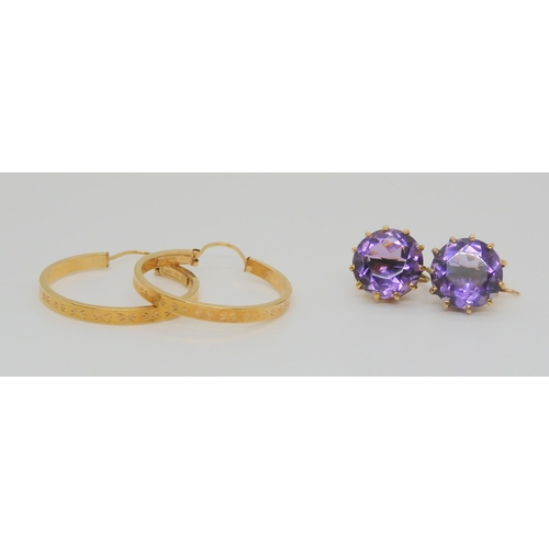 719 - A pair of Italian made creole earrings, together with a pair of yellow metal amethyst earrings with ... 