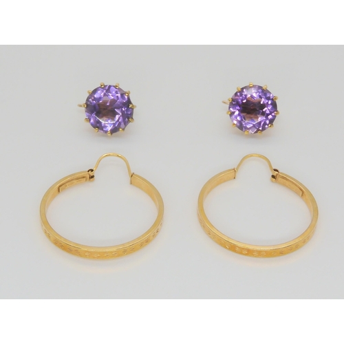 719 - A pair of Italian made creole earrings, together with a pair of yellow metal amethyst earrings with ... 