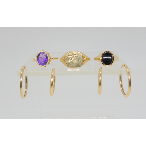722 - Three 9ct gold rings and two pairs of yellow metal hoop earrings, signet ring size Z1/2, amethyst Q,... 