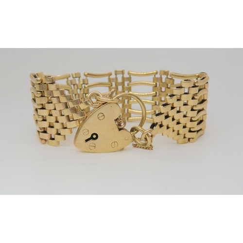723 - A 9ct gold  gate bracelet, with heart shaped clasp, length 17cm, weight 31.4gms 