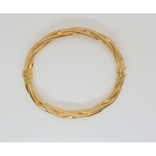 724 - A 9ct gold barley twist bangle, inner dimensions 6cm x 5.5cm, weight 10.3gms