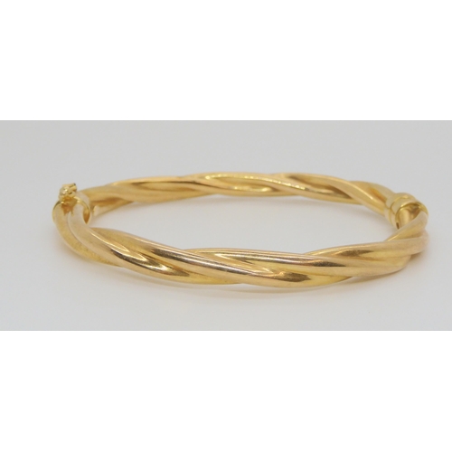 724 - A 9ct gold barley twist bangle, inner dimensions 6cm x 5.5cm, weight 10.3gms