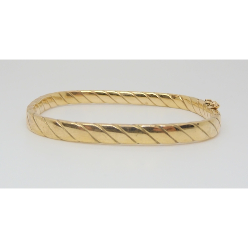 725 - A 9ct gold twist pattern square bangle, inner dimensions 6cm x 5.2cm, weight 9.9gms