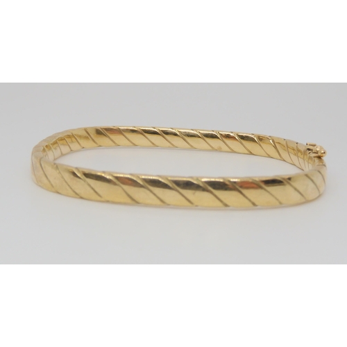 725 - A 9ct gold twist pattern square bangle, inner dimensions 6cm x 5.2cm, weight 9.9gms