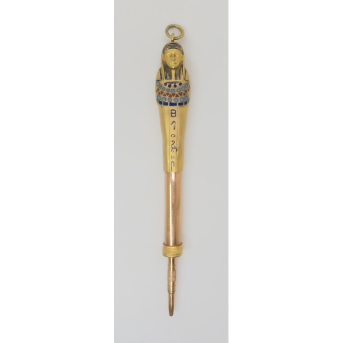 733 - A gilded white metal enamelled propelling pencil in the shape of an Egyptian Sarcophagus, open lengt... 