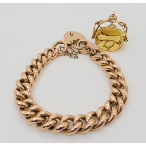 736 - A 9ct gold wide curb chain bracelet with heart shaped clasp, and a 9ct gold citrine fob seal. Width ... 