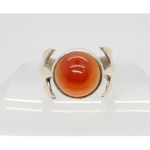 743 - A silver retro statement ring by Peter Guy Watson, set with a carnelian, hallmarked London 1972, fin... 