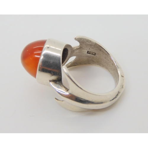 743 - A silver retro statement ring by Peter Guy Watson, set with a carnelian, hallmarked London 1972, fin... 