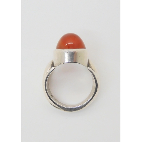 743 - A silver retro statement ring by Peter Guy Watson, set with a carnelian, hallmarked London 1972, fin... 