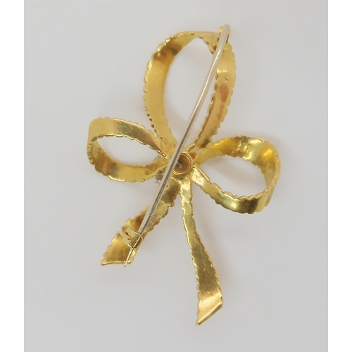 746 - An 18ct gold and diamond bow brooch made by Cropp & Farr Ltd, set with estimated approx 0.38cts ... 