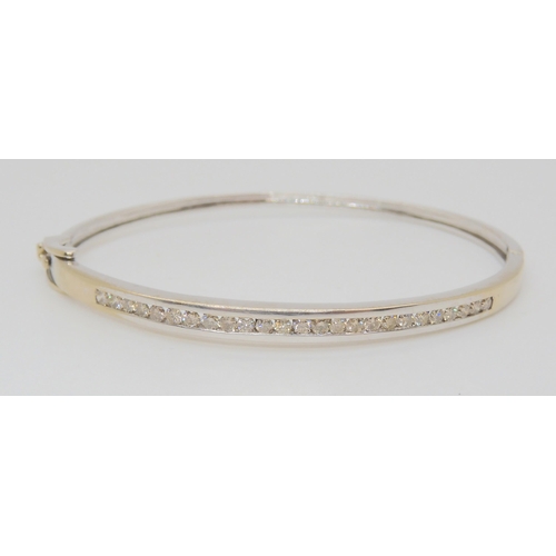 757 - A 9ct white gold diamond bangle, set with estimated approx 0.75cts of brilliant cut diamonds, inner ... 