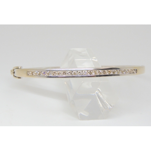 757 - A 9ct white gold diamond bangle, set with estimated approx 0.75cts of brilliant cut diamonds, inner ... 