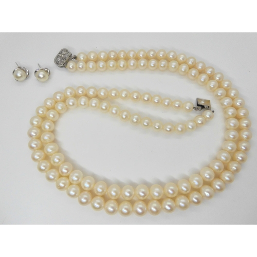 759 - A double string of large cultured pearls of slightly baroque shape with matching earrings, each pear... 