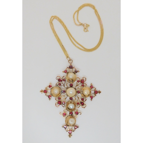 763 - A large pearl and garnet set cross, mounted in yellow metal, of foliage design, dimensions 8.8cm x 6... 