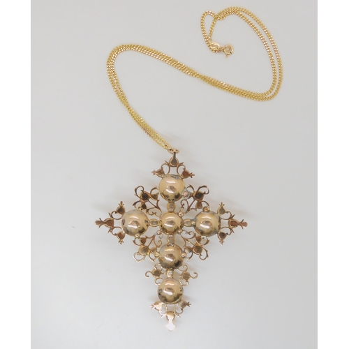 763 - A large pearl and garnet set cross, mounted in yellow metal, of foliage design, dimensions 8.8cm x 6... 