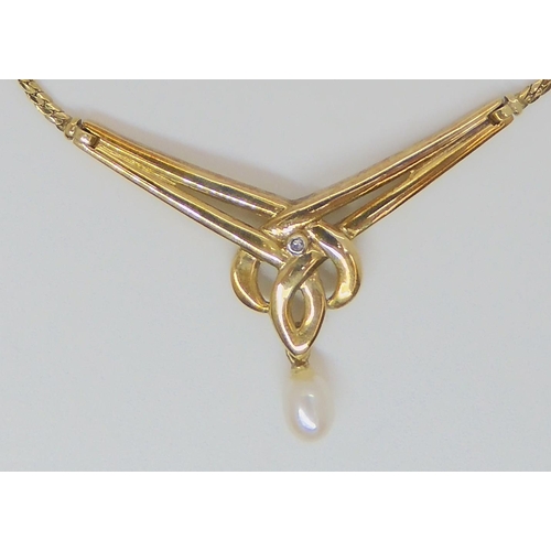 768 - A 9ct gold knotwork necklet with a pearl drop and set with a diamond accent, length of knot panel 4.... 