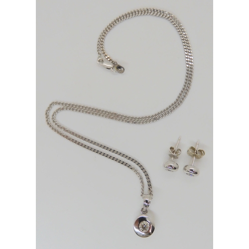 775 - An 18ct white gold pendant set with an estimated approx 0.25ct diamond, with matching earrings set w... 