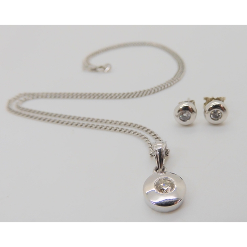 775 - An 18ct white gold pendant set with an estimated approx 0.25ct diamond, with matching earrings set w... 