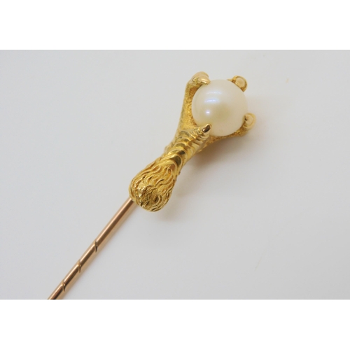 784 - A bright yellow metal eagles claw lapel pin, the talons clutching a 8.5mm pearl, length of pin 8cm, ... 