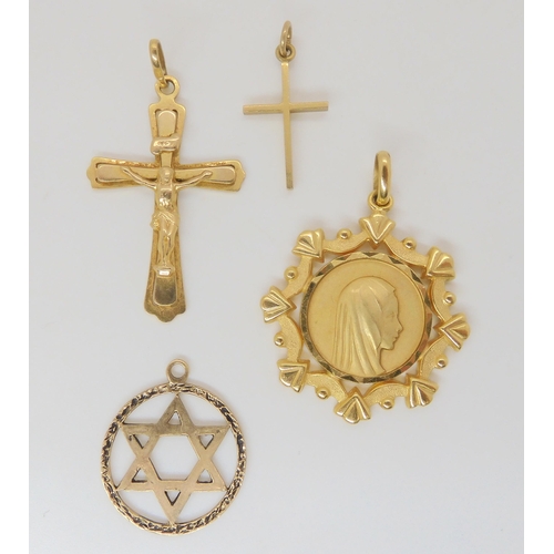 786 - A collection of 9ct and yellow metal, a crucifix, cross, star of David and Madonna pendant, weight t... 