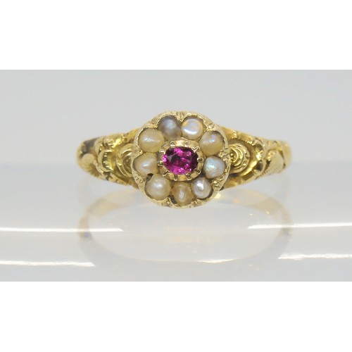 748 - A Victorian locket ring, the hinged cover set with a ruby and pearls, with a yellow metal flower emb... 