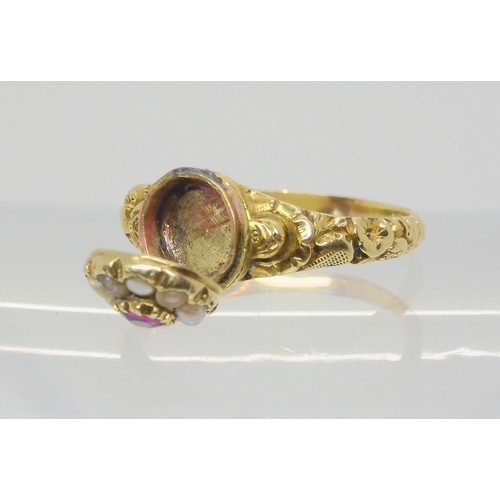 748 - A Victorian locket ring, the hinged cover set with a ruby and pearls, with a yellow metal flower emb... 