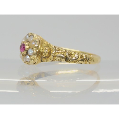 748 - A Victorian locket ring, the hinged cover set with a ruby and pearls, with a yellow metal flower emb... 