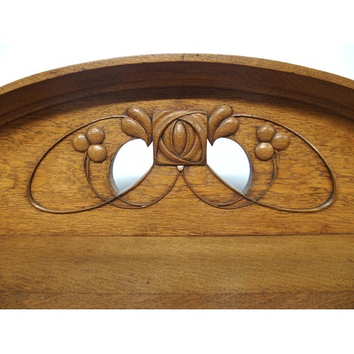 2015A - AN EARLY 20TH CENTURY BLONDE OAK ARTS & CRAFTS SIDEBOARDwith carved pierced motif over three ope... 