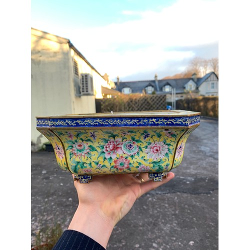 2401 - A CANTON ENAMEL YELLOW GROUND JARDINIERE Painted with peonies and scrolling foliage, beneath a blue ... 