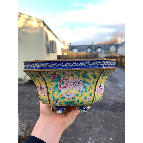 2401 - A CANTON ENAMEL YELLOW GROUND JARDINIERE Painted with peonies and scrolling foliage, beneath a blue ... 