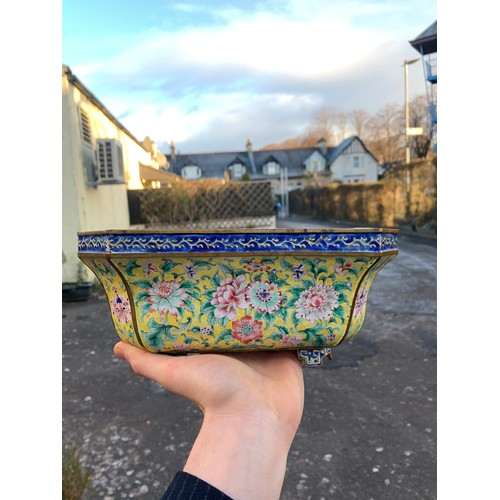 2401 - A CANTON ENAMEL YELLOW GROUND JARDINIERE Painted with peonies and scrolling foliage, beneath a blue ... 