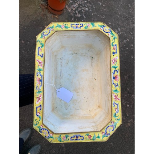 2401 - A CANTON ENAMEL YELLOW GROUND JARDINIERE Painted with peonies and scrolling foliage, beneath a blue ... 