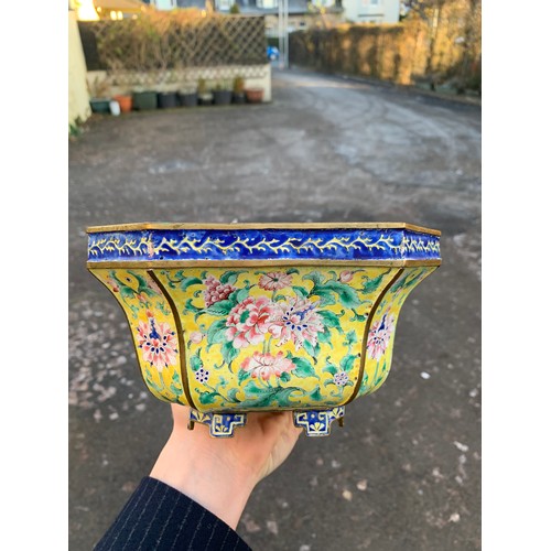 2401 - A CANTON ENAMEL YELLOW GROUND JARDINIERE Painted with peonies and scrolling foliage, beneath a blue ... 