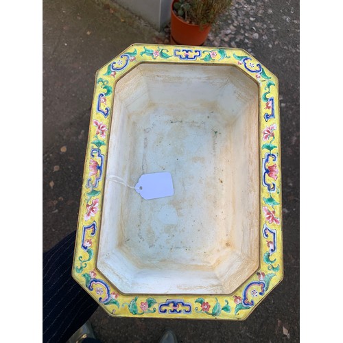 2401 - A CANTON ENAMEL YELLOW GROUND JARDINIERE Painted with peonies and scrolling foliage, beneath a blue ... 