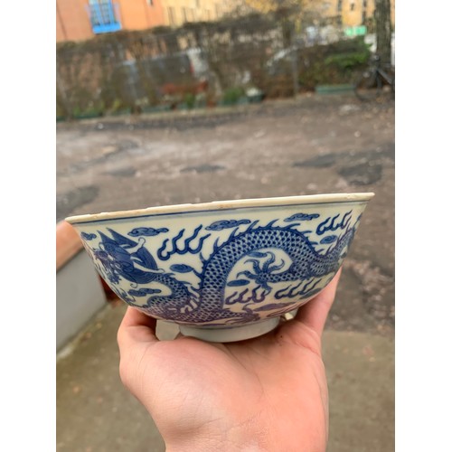 2392 - A CHINESE CELADON GLAZED BOWL Carved with foliage, 19.5cm diameter and a blue and white dragon bowl,... 