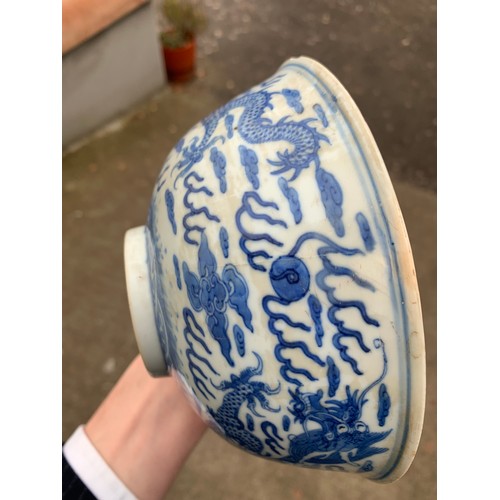 2392 - A CHINESE CELADON GLAZED BOWL Carved with foliage, 19.5cm diameter and a blue and white dragon bowl,... 