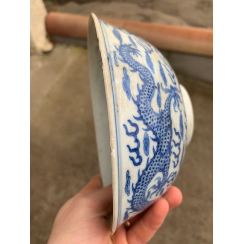 2392 - A CHINESE CELADON GLAZED BOWL Carved with foliage, 19.5cm diameter and a blue and white dragon bowl,... 