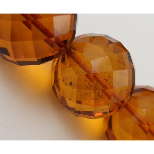 106 - Item 11. An orange diamond amber coloured statement necklace