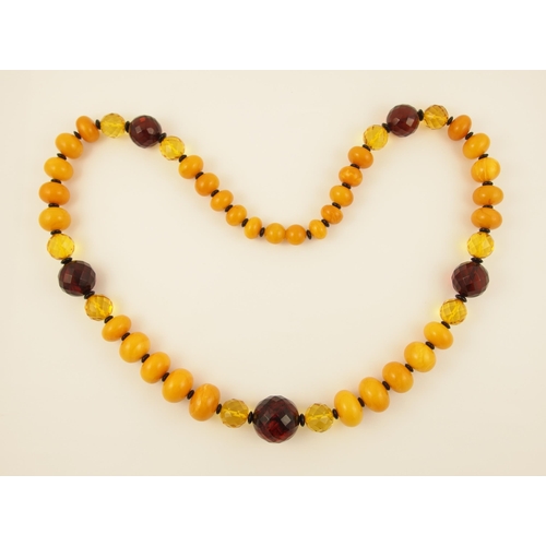 107 - Item 12. A mixed amber coloured bead necklace