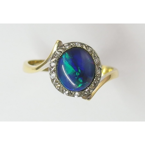 65 - An 18ct black opal and diamond ring