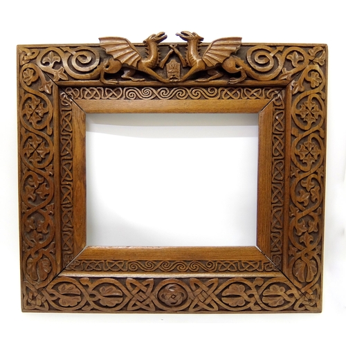 702 - Manner of ALEXANDER RITCHIE an elaborately carved oak picture frame